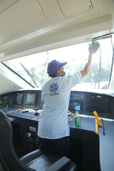 Ultra staff cleaning the windscreen inside a Vande Bharat Express cab