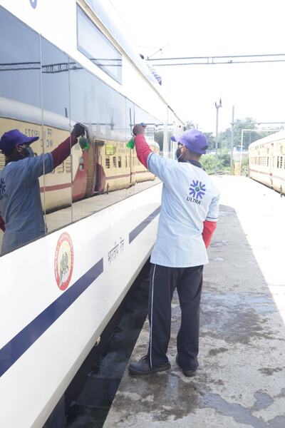 Washing coach windows on the platform
