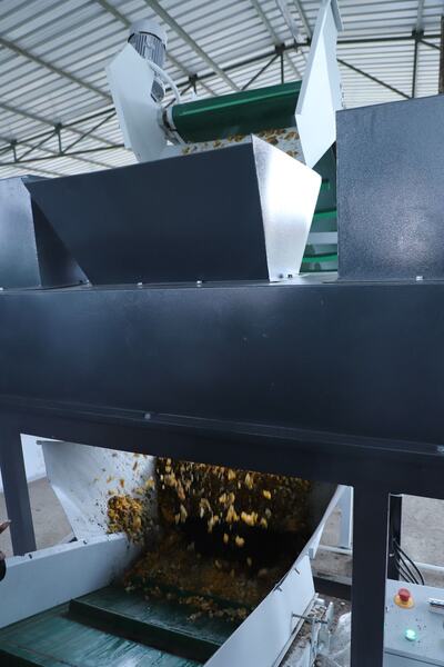 Shredded waste leaving the shredder