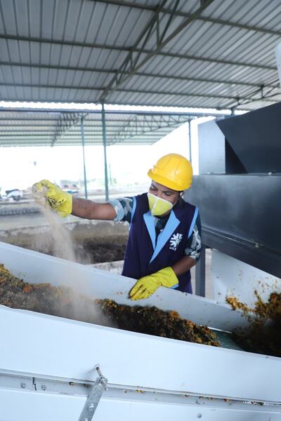 Sprinkling odour-control powder on organic waste