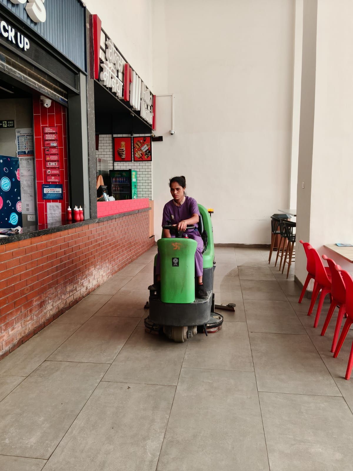 Ultra staff operating a ride-on floor scrubber at Zora Mall